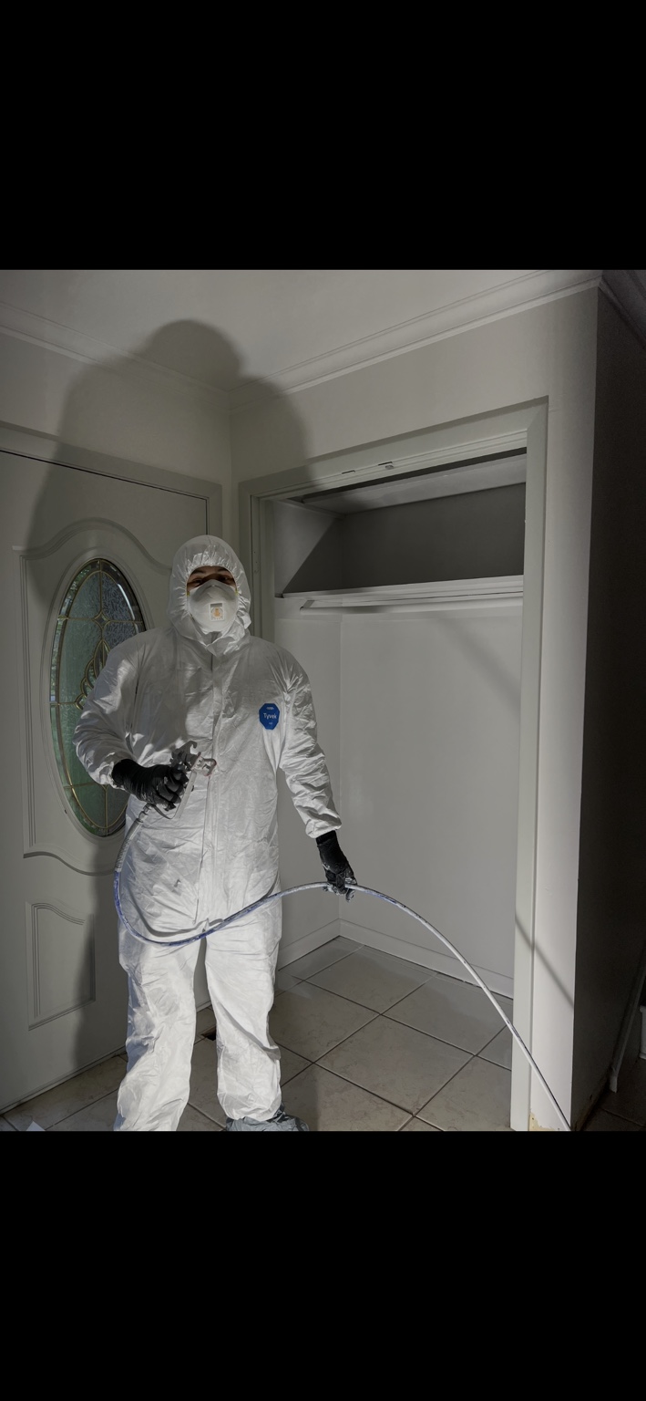 Hugo wearing protective equipment while completing professional painting work